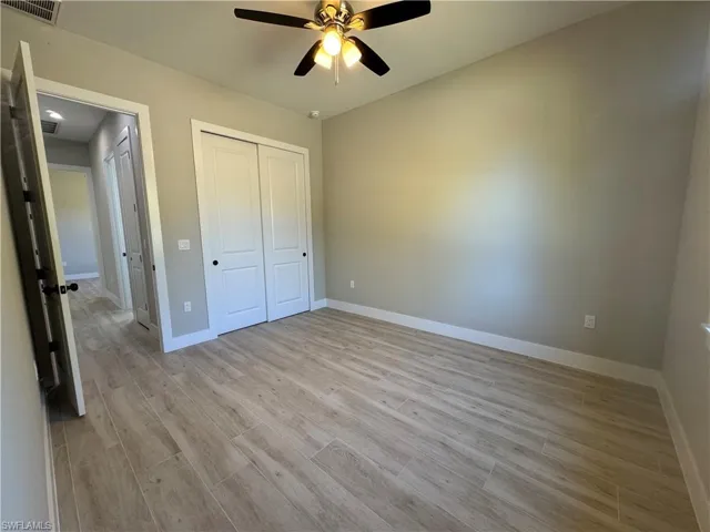 Unfurnished bedroom a ceiling fan, and a closet