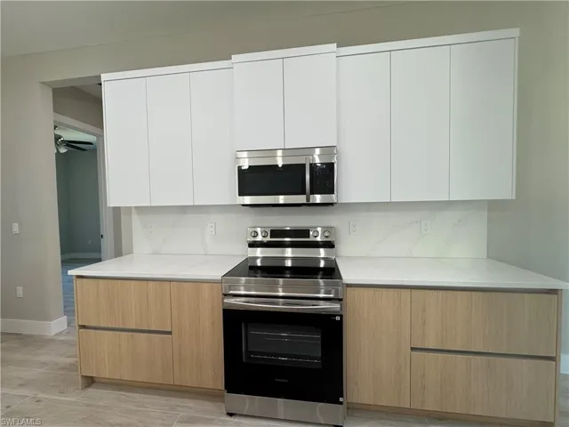 Kitchen with modern cabinets, stainless steel appliances.