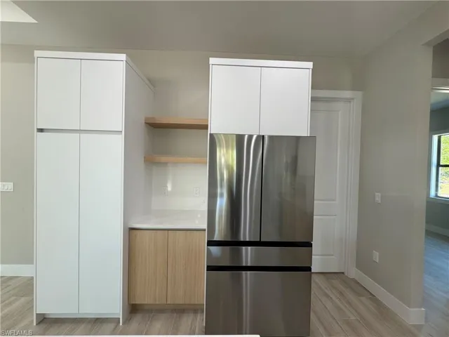 Kitchen with open shelves and modern cabinets.