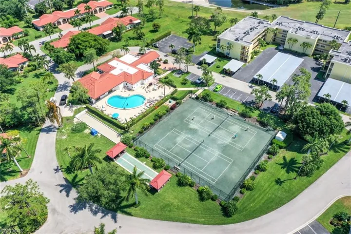 Bird's eye view of a nearby body of water and a pool area