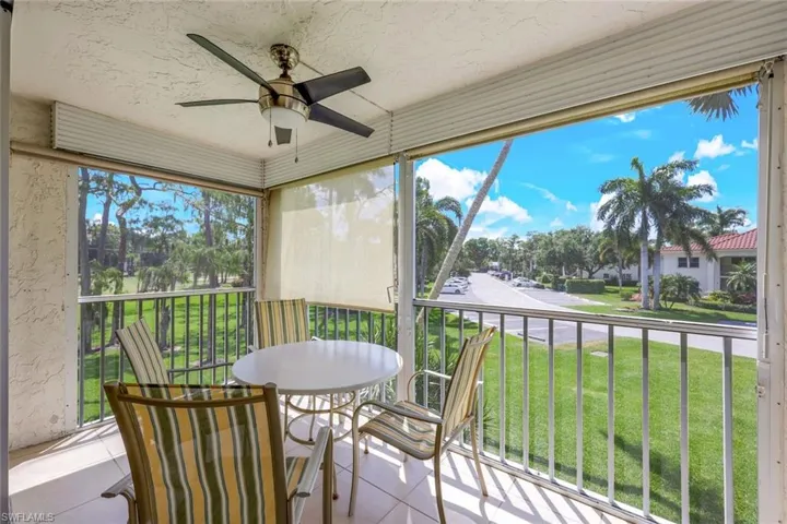 Sunroom with a ceiling fan, a balcony, and healthy amount of natural light