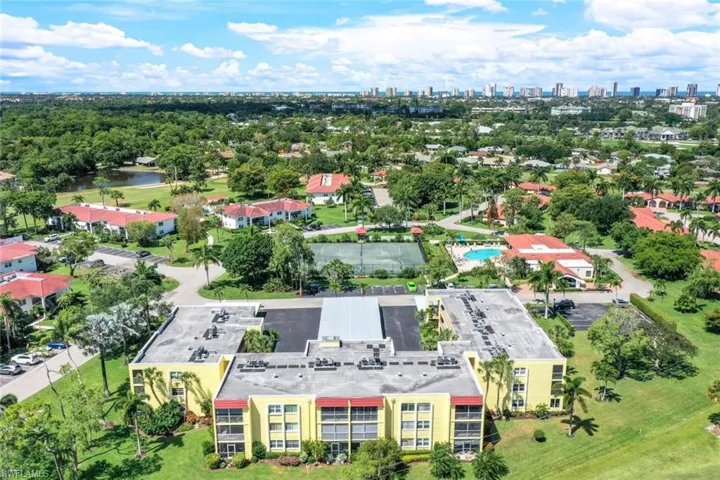 Bird's eye view of a nearby body of water and apartment complex / building