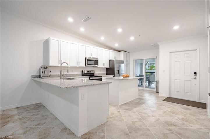 Lovely Kitchen with Sliders that lead out to the front covered Lanai