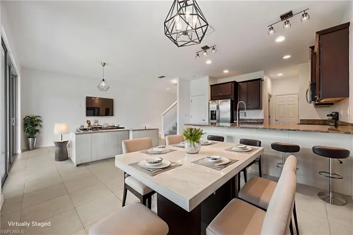Dining room with light tile patterned floors, stairway, and recessed lighting Virtually Staged