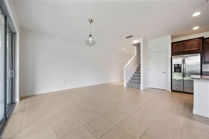 Living Room Area with new carpeted stairs, Under stair Closet.