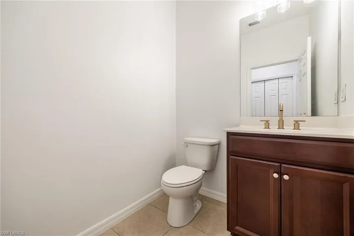 Half Bathroom featuring vanity and tile patterned floors