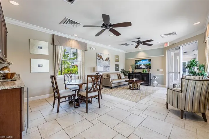 Club House with healthy amount of natural light, ornamental molding, recessed lighting, ceiling fan, and light tile patterned floors