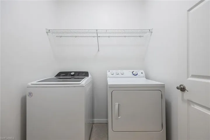 Washroom featuring washing machine and dryer
