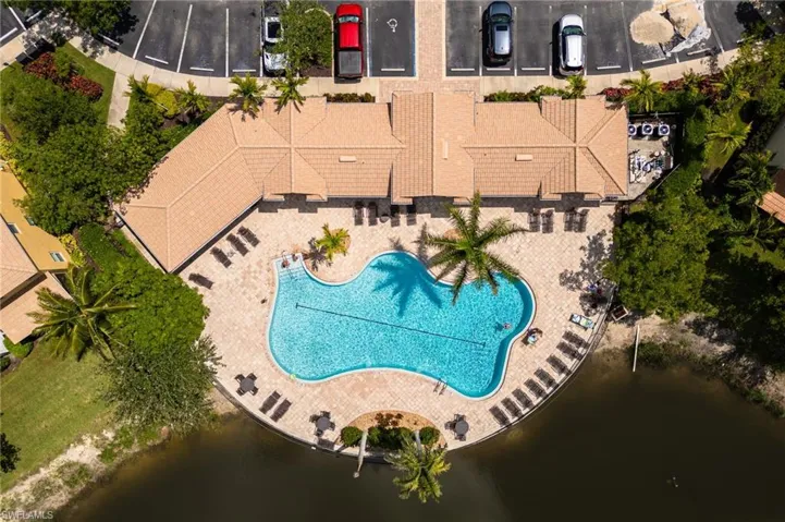 Aerial view of a pool and a nearby body of water
