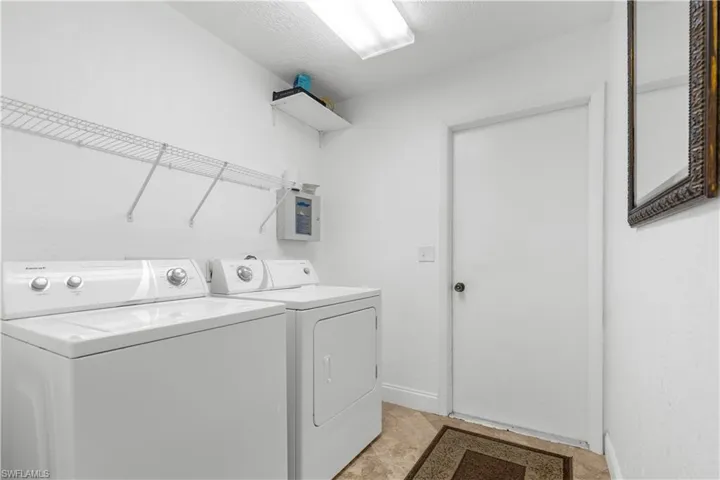 Laundry room featuring washer and dryer and electric panel