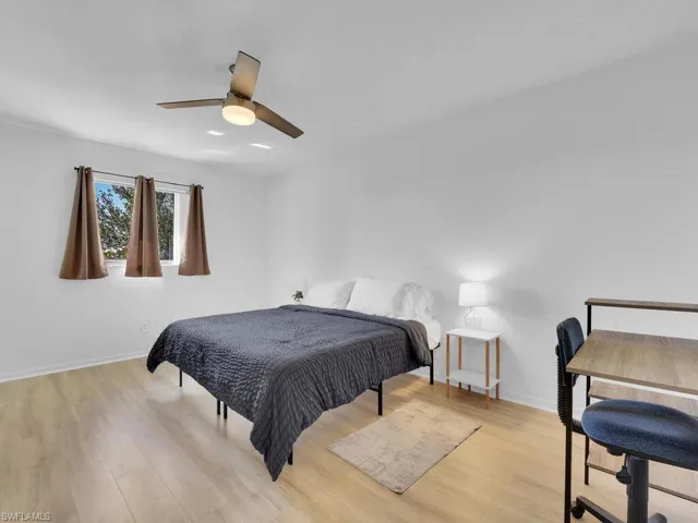 Bedroom with light hardwood / wood-style floors and ceiling fan