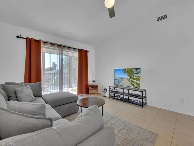 Tiled living room featuring ceiling fan