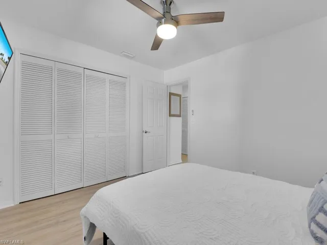 Bedroom featuring a closet, light hardwood / wood-style flooring, and ceiling fan