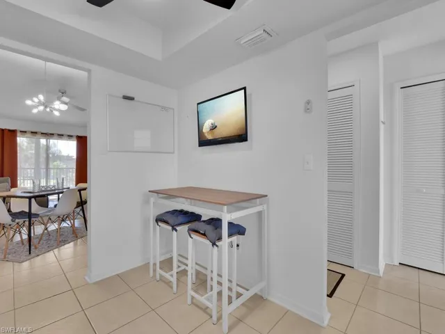 Dining space featuring ceiling fan and light tile patterned flooring