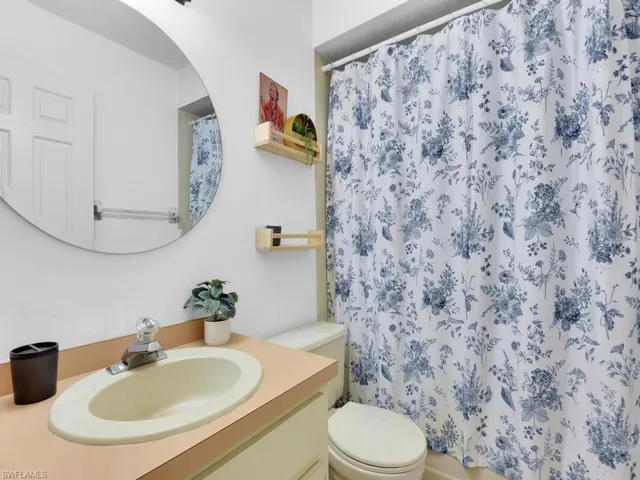 Bathroom featuring vanity, toilet, and walk in shower