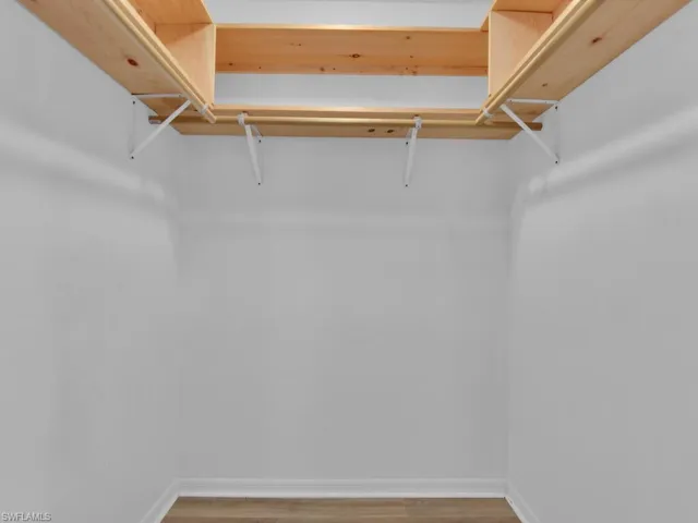 Spacious closet featuring hardwood / wood-style floors