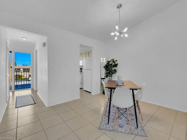 Dining room featuring a notable chandelier and light tile patterned flooring