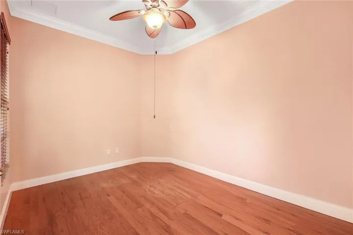 Den with double door entry, window to the front, nice wood flooring and crown molding.