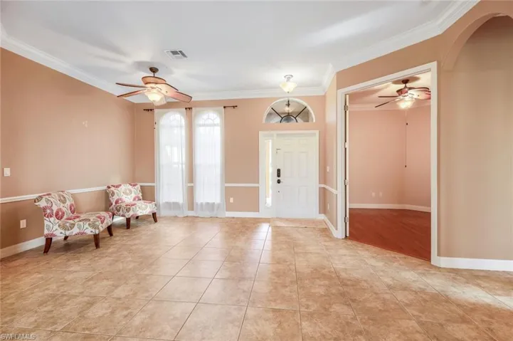 Bright, elegant, spacious entryway, Formal Dining area and double doorway to den.