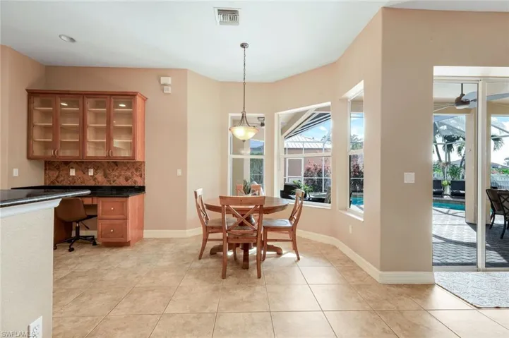 Eat-in kitchen dining area with a view of the pool.