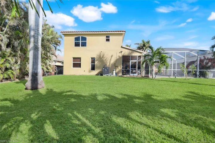 Spacious yard area green space with mature landscaping.