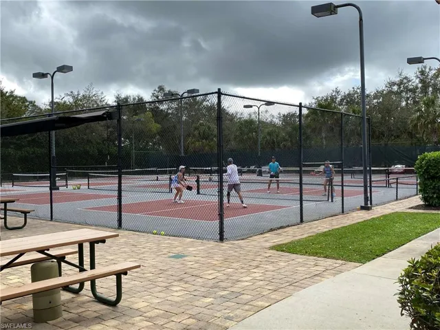 New Pickle ball courts, Bocce courts Multi-court recreational facility featuring chain-link fencing, overhead pole lighting, paved hardscaping, and a picnic area