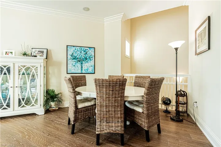 Dining room with ornamental molding, baseboards, and wood finished floors