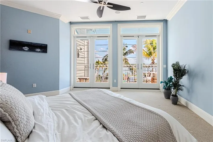Bedroom featuring crown molding, french doors, visible vents, and access to exterior