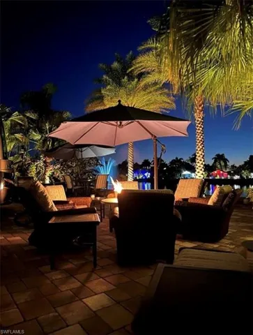 Patio at twilight with an outdoor living space with a fire pit
