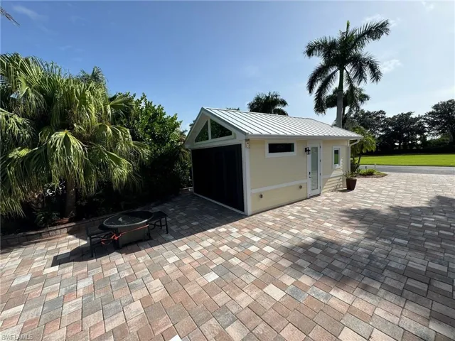 View of patio / terrace featuring a fire pit and an outbuilding