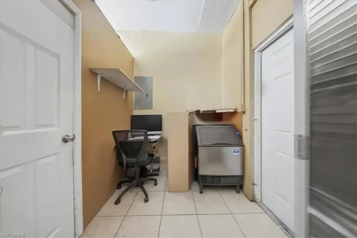 Office featuring electric panel and light tile patterned floors