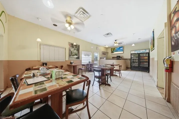 Dining space with a ceiling fan and light tile patterned floors
