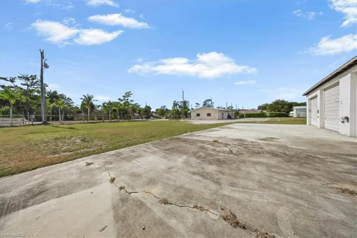 View of grassy yard featuring a garage