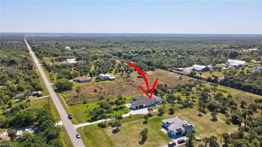Birds eye view of property with a forest view