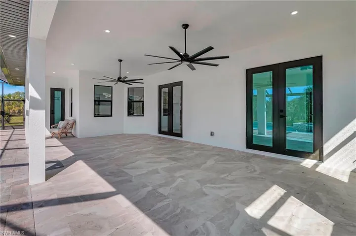 View of patio with french doors and ceiling fan