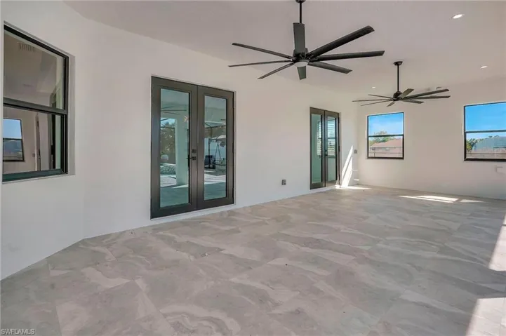 View of patio with french doors and a ceiling fan