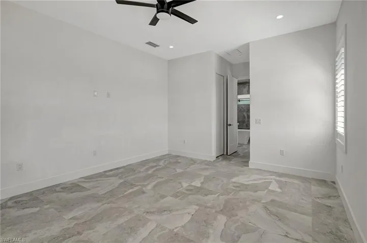 Unfurnished room featuring visible vents, marble finish floor, recessed lighting, baseboards, and ceiling fan