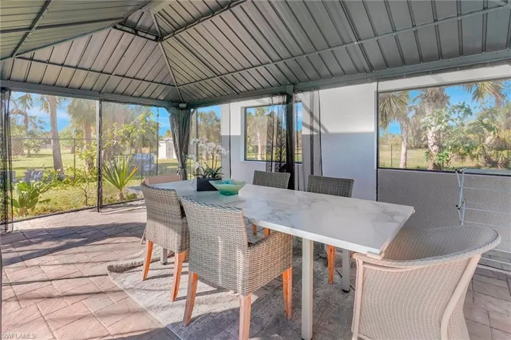 Sunroom / solarium featuring lofted ceiling