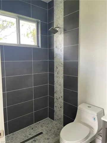Full bath with a shower stall and vanity