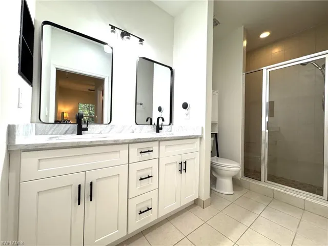 Primary bathroom with new double vanity with drawers and granite countertop. Spacious walk-in shower!