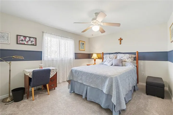 Rear guest bedroom with walk-in closet with pocket door