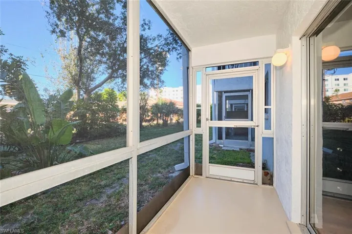 Screened lanai with entry to bedroom.
