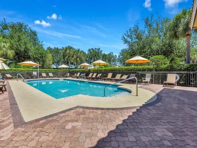 Pool featuring fence and a patio area