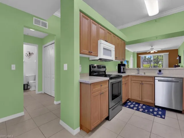 Kitchen featuring light countertops, stainless steel appliances, visible vents, and light tile patterned floors