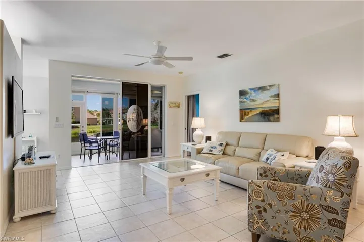 Living room featuring a ceiling fan and light tile patterned floors