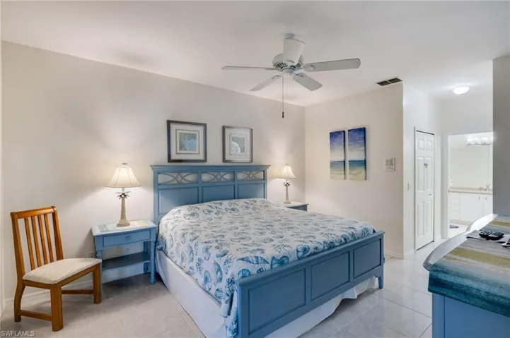 Bedroom featuring a closet, a ceiling fan, connected bathroom, and light tile patterned floors