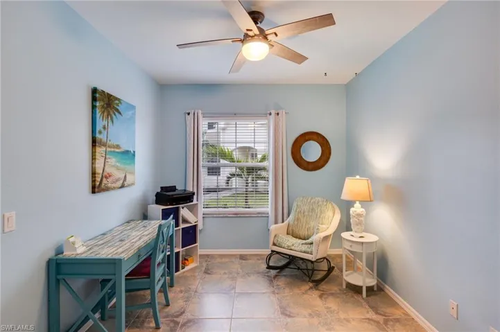 Sitting room with a ceiling fan and baseboards