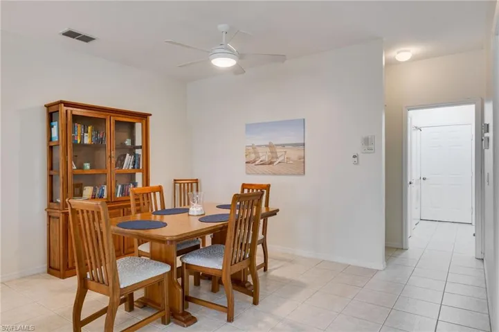 Dining space featuring ceiling fan and light tile patterned floors