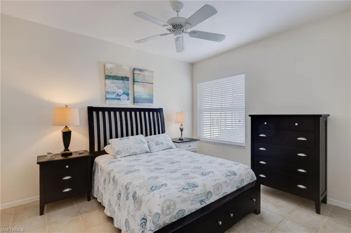 Bedroom featuring ceiling fan and light tile patterned flooring