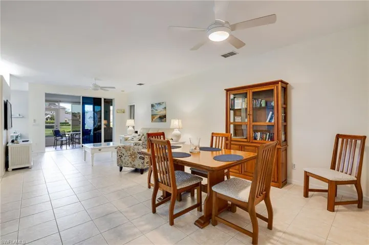 Dining space with ceiling fan and light tile patterned floors